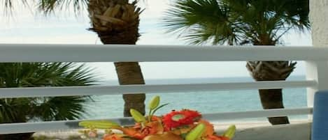 Inn on the Beach 1-205 beachfront balcony with dining table for four