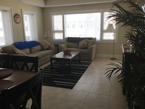 Living/family room has queen sized sofa bed and access to balcony.