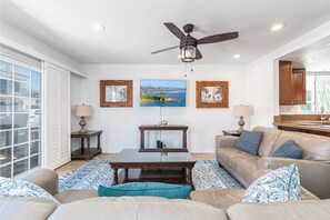 Spacious living room looks out to front ocean view patio, with easy access through sliding glass doors.
                
