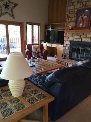 Large family room with beautiful stone fireplace.
