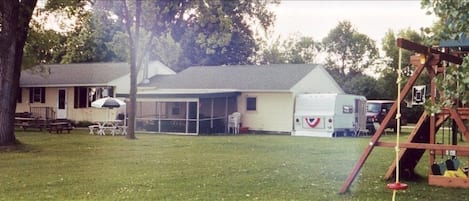 The cabin and big yard w/ 2 kids play systems!