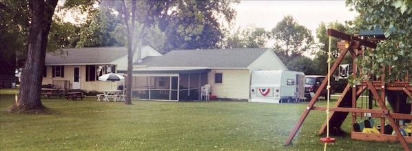 The cabin and big yard w/ 2 kids play systems!