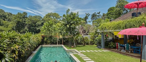 Long private pool with manicured tropical garden