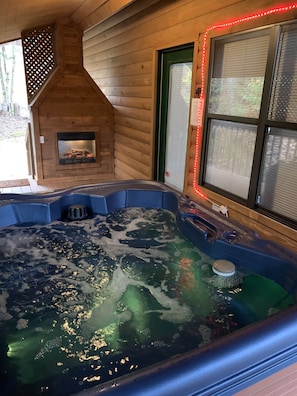 C’mon in the bubbling, light changing hot tub to soak away the day!