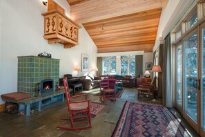 Living room with radiant-heated stone floors and Kachlofen fireplace 