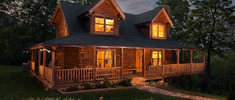 Front view of cabin at dusk. 
