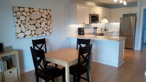 Dining table has two pull-out extensions. Photo art by Robin Rezende