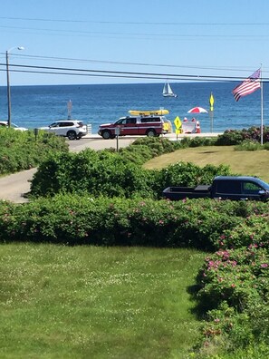 Our upper deck view of Life guards' vehicle and life guards' chair on the beach.