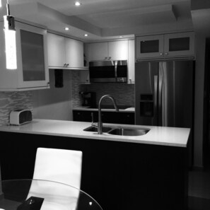 Open concept kitchen with counter top, microwave/convection oven and w/d combo
