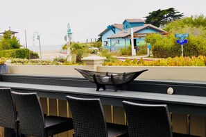 Sit at the patio bar have a drink and an appetizer viewing the beach & mountain