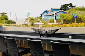 Sit at the patio bar have a drink and an appetizer viewing the beach & mountain
