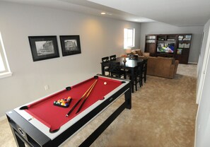 Lower level common area with 48' flat screen TV, Xbox One, and pool/air hockey.