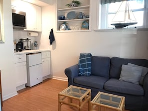 Bright living room. Out door cafe table and seating for two is adjacent.