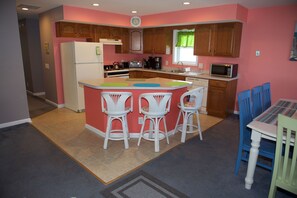 Fully stock kitchen with island and seating for 3.