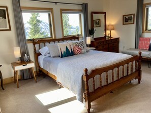 Queen bed with quality organic cotton bedding, blackout blinds  and drapes.