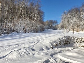 Uphill.  Runs right by lodge for easy ski in and ski out.  