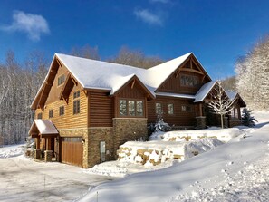 Front of lodge and side.  Parking and entrance on lower level. 