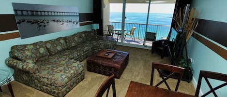 A large living room overlooking the ocean on this large comfy sofa. 