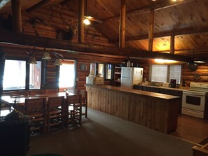 The open kitchen and dining room - windows overlooking the lake. 