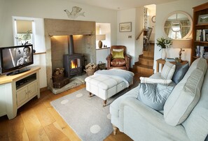 Ground floor: The sitting room with comfortable leather sofas and wood burning stove