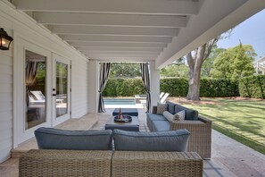 Covered patio off the downstairs bedroom, overlooking hot tub and spacious lawn.