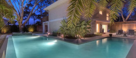 Twilight view of expansive private pool