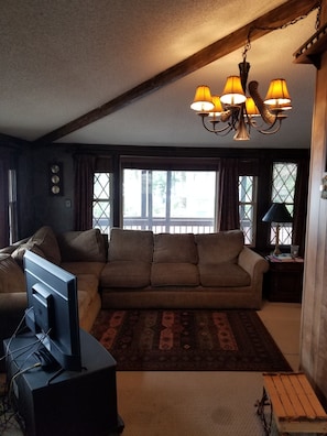 Living room with large windows to deck 