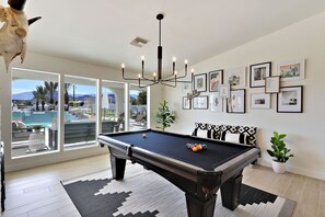 Game room with pool table that also converts to a ping pong table.