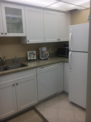 Kitchen with Microwave, dishwasher and refrigerator. 