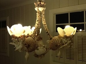 Seashell chandelier made by a local artist illuminate the dining area.