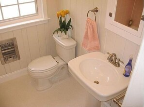 Charming bath with tub and shower.