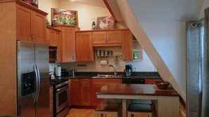 Kitchen with refrigerator, dishwasher, gas stove, and microwave to cook.