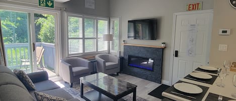 Living room with feature fireplace, 50" TV (Cable & Netflix) and Queen Sofabed