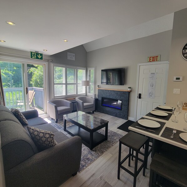 Living room with feature fireplace, 50" TV (Cable & Netflix) and Queen Sofabed