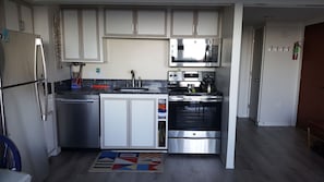 Updated kitchen with new appliances, granite counters, & woodlook vinyl flooring