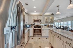 Kitchen (with custom cabinets, granite counters and stainless steel appliances).