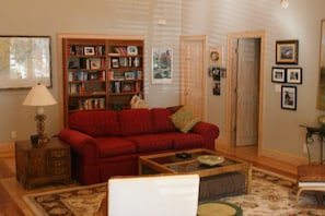 Living room with doors to master bedroom and laundry room.
