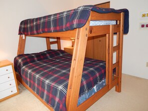 upstairs bedroom with double bed on bottom and single on top.