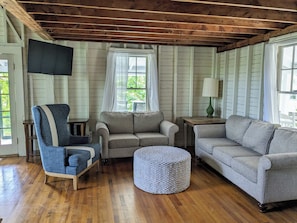 living room area with plenty of seating and flats green TV