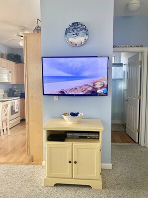 Smart TV with cable and VCR. There are fun family board games in this cabinet.