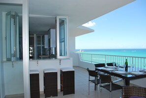 Kitchen opens into the terrace through a bar area counter