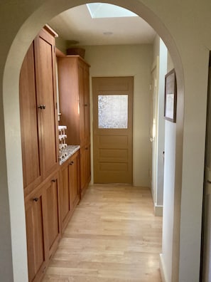 Custom cherry wood pantry off of the kitchen