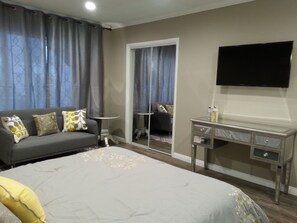 Queen size bed with sitting area and HD TV