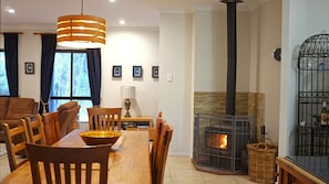 Dining table in the heart of the house, cosy fire