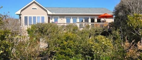 View of house from end of private boardwalk to beach.