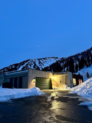 The Alta Bird Chalet's green garage faces Highway 210