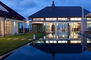 Infinity pool and house at dusk