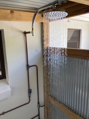 Outdoor beach bathroom with hot & cold water shower, basin and toilet.