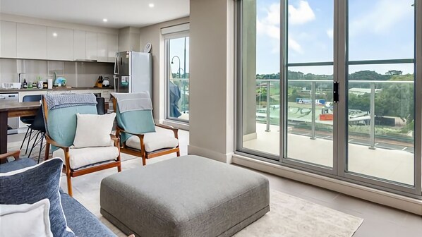 Lounge with access to sliding doors to the balcony with BBQ and views.