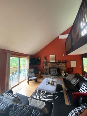 Main level living room, with view of upstairs loft. 